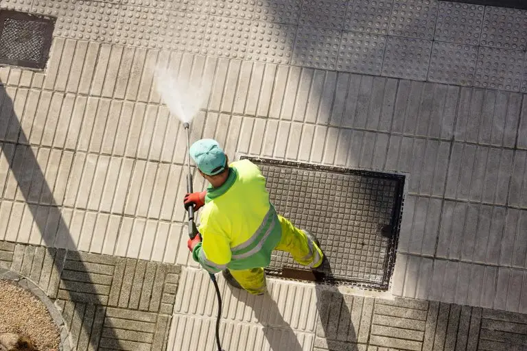 worker-cleaning-a-street-sidewalk-with-high-pressu-2025-02-22-16-15-39-utc-min